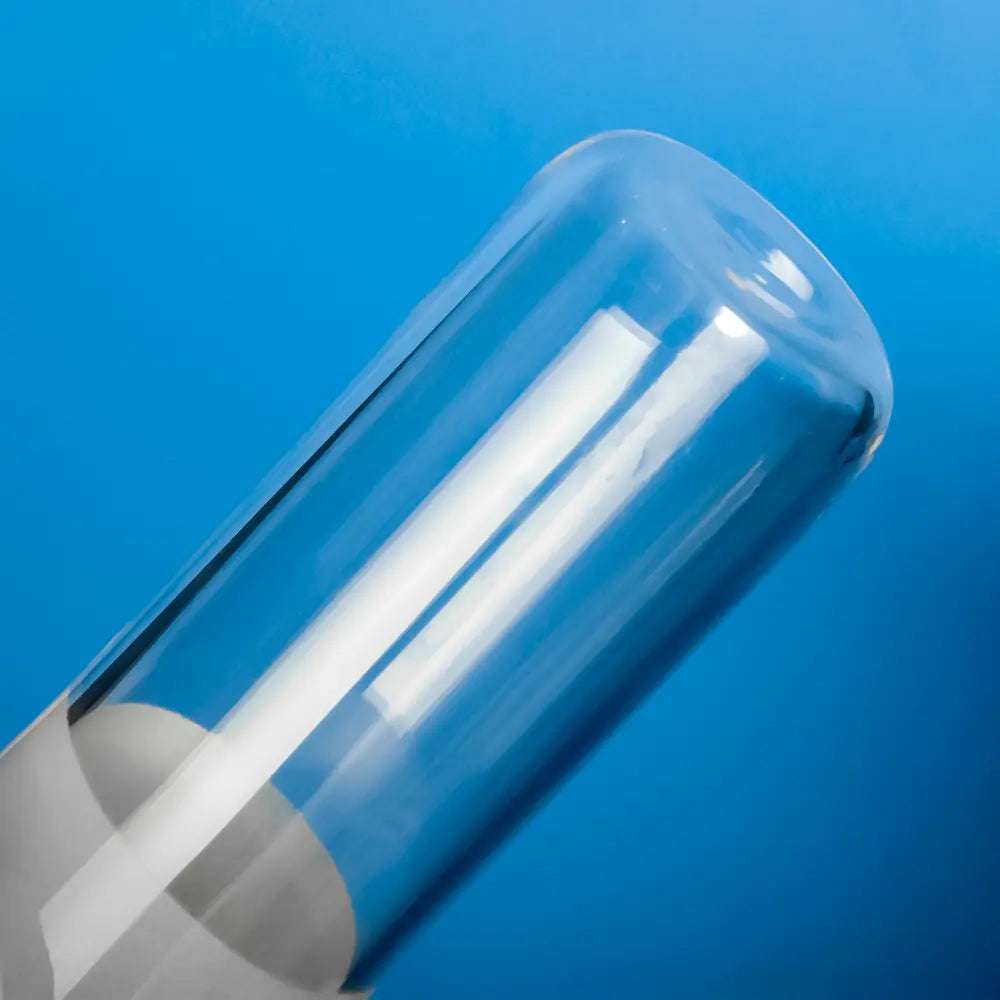 A gloved hand holds a frosted quartz test tube plug, highlighting its textured frosted surface and clear glass design