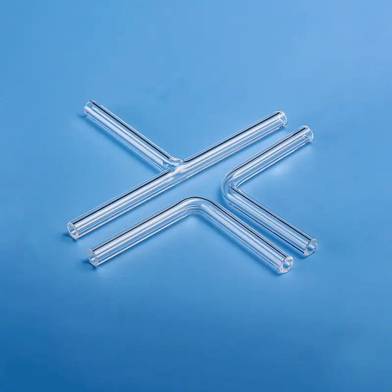 Assortment of clear quartz glass tubes for laboratory use, including L-bend and T-tube shapes, showcasing precision fabrication.