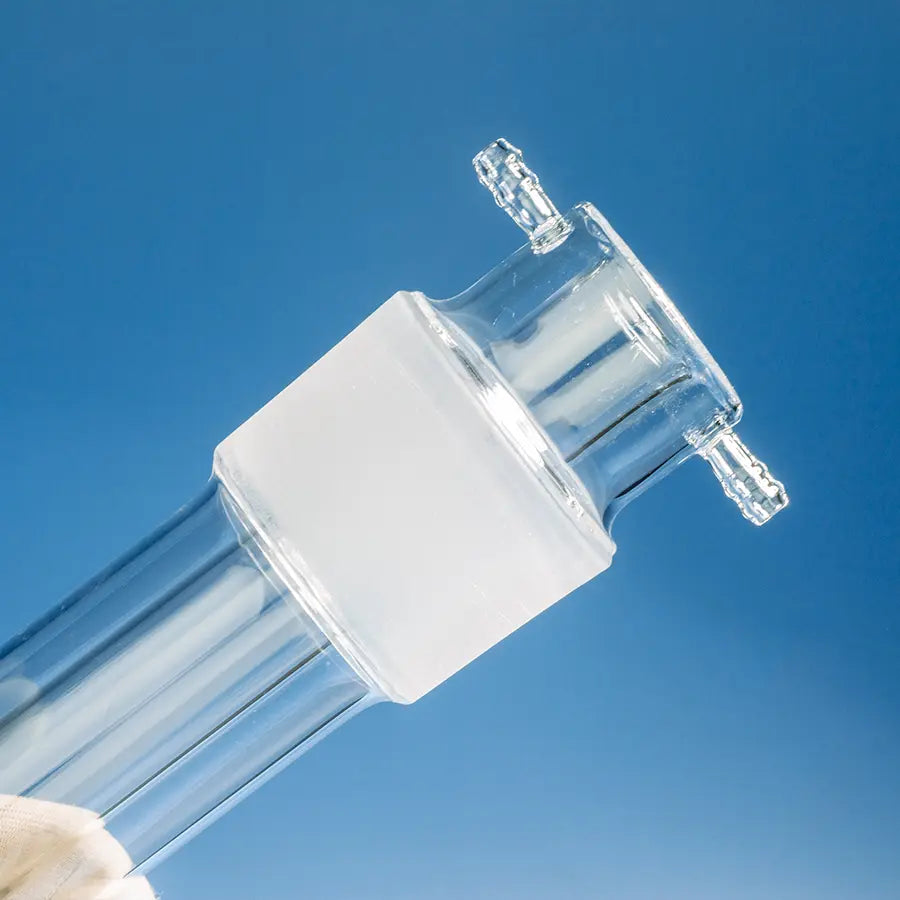 Close-up of the top connection of a lab quartz reaction tube with inlets and outlets for gas and liquid