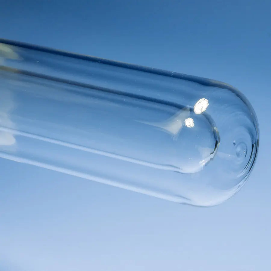 Close-up view of the rounded, sealed bottom of a double-walled quartz photochemical reaction tube