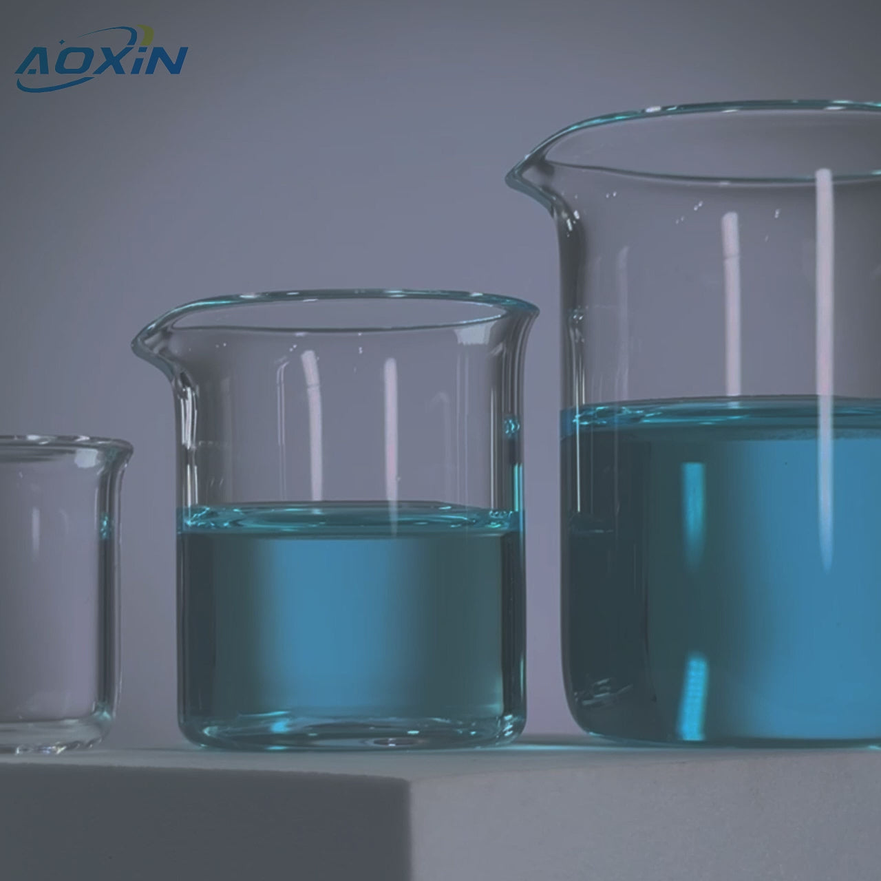 Three high purity quartz glass beakers filled with blue liquid, demonstrating heat resistance and application