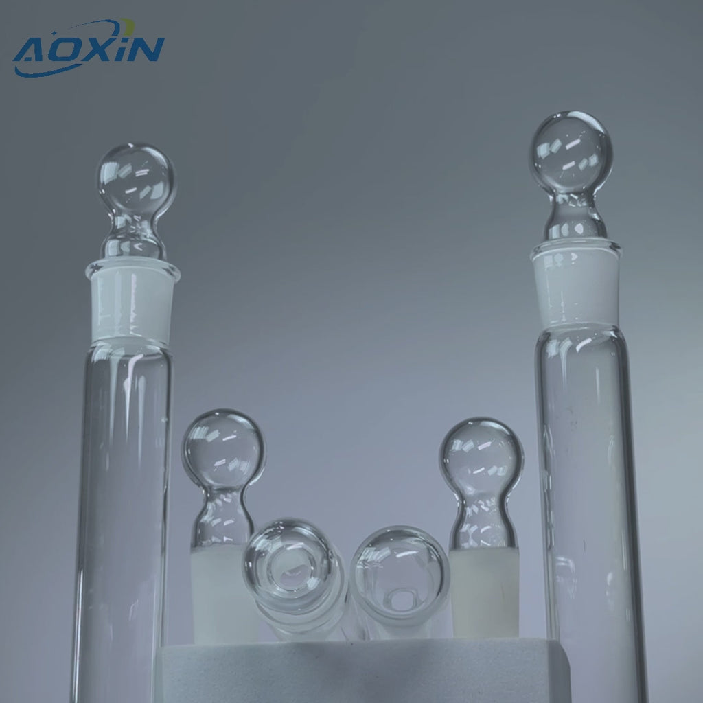 Two clear high purity quartz reaction tubes with stoppers, demonstrating 1200°C heat resistance and acid/alkali corrosion resistance