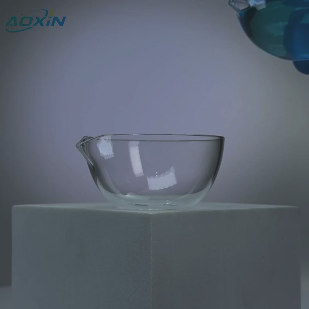 High purity quartz evaporating dish receiving a pour of blue liquid, demonstrating its use and heat-resistant properties